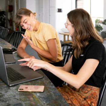 Co-workers using a laptop